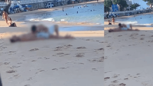 Homem pratica sexo oral em outro na areia da praia em plena luz do dia