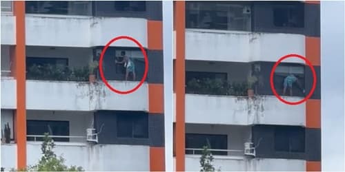 Mulher limpa janela de apartamento sem equipamentos de segurança na Bahia